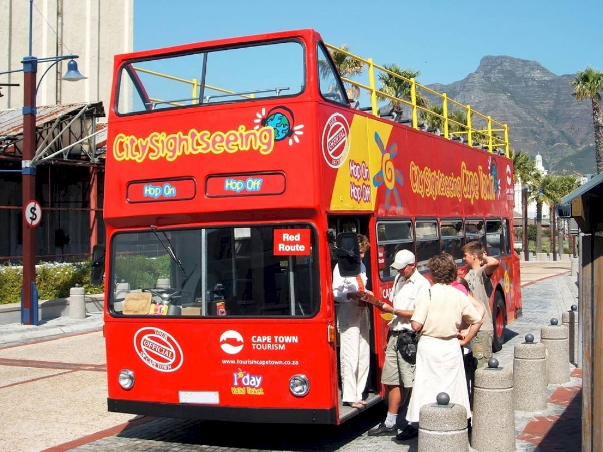 A red double-decker sightseeing bus labeled 